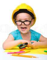 Cute little girl is playing while wearing hard hat