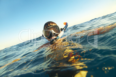 boy floats in the sea