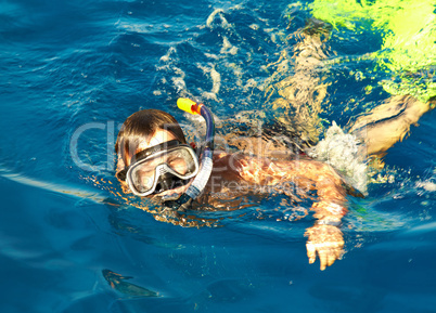 boy floats in the sea