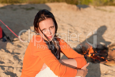 Camping woman relax on beach by  campfire