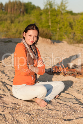 Camping woman relax on beach by  campfire