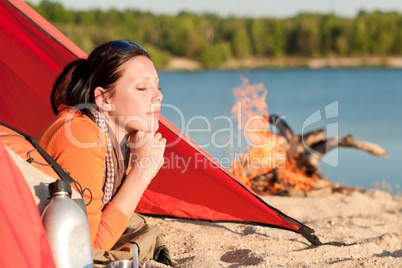 Camping happy woman relax in tent by campfire