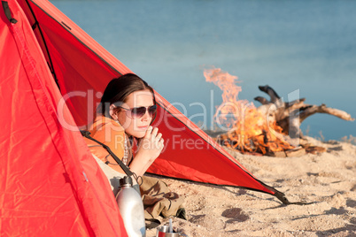 Camping happy woman relax in tent by campfire