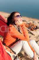 Camping beach woman by campfire in tent