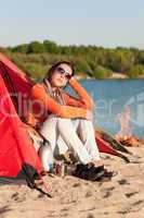 Camping beach woman by campfire in tent