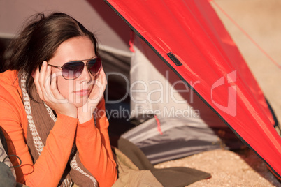 Camping happy woman lying in tent alone