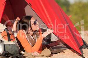 Camping happy woman in tent on beach