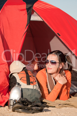 Camping happy woman in tent on beach