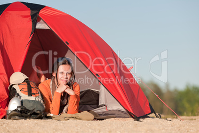 Camping happy woman in tent on beach