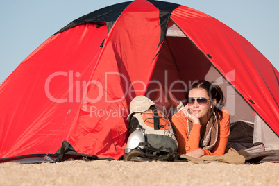 Camping happy woman in tent on beach