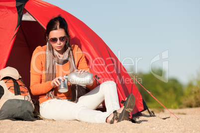 Camping happy woman sitting front of tent