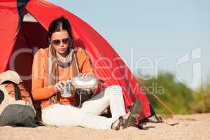 Camping happy woman sitting front of tent