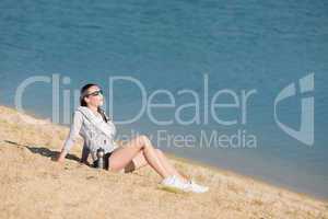 Summer sport fit woman sitting on beach