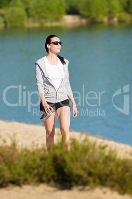 Summer sport fit woman walk on seaside beach