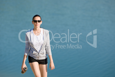 Summer sport fit woman walk on beach