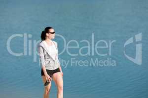 Summer sport fit woman walk on beach