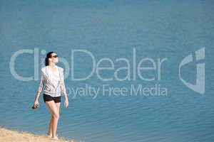 Summer sport fit woman walk on beach