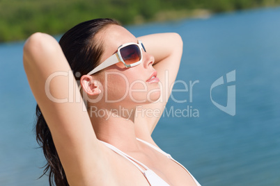 Young sexy bikini model relaxing with sunglasses