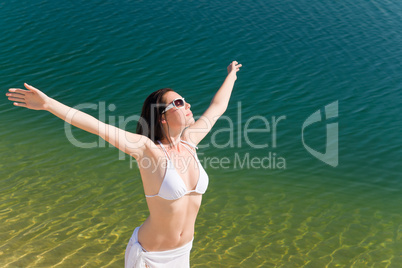 Summer young woman on seashore in bikini