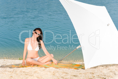 Young sexy bikini model relaxing with sunglasses