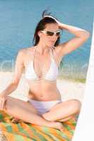 Young sexy bikini model relaxing with sunglasses