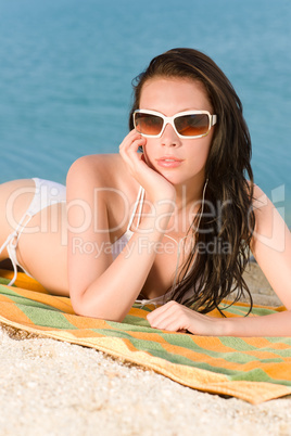 Young sexy bikini model relaxing with sunglasses