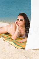 Young sexy bikini model relaxing with sunglasses