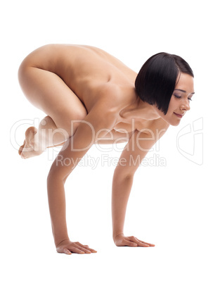 Young nude woman in yoga pose arm balance