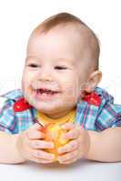 Little child is eating red apple and smile