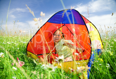 Girl is playing outdoors under tent
