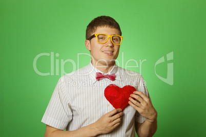 Smiling guy holding heart shape