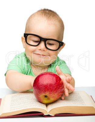 Little child is playing with red apple Little child is playing with red apple