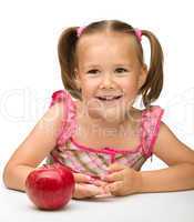 Portrait of a little girl with apple