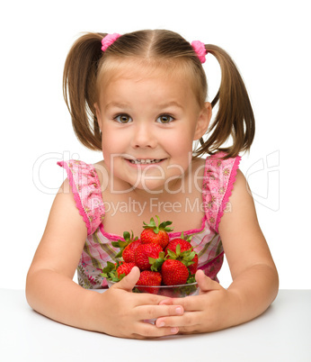 Happy little girl with strawberries