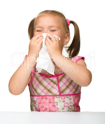 Little girl blows her nose