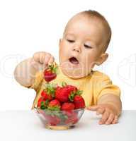 Happy little girl with strawberries