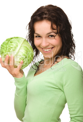 Beautiful young girl with green cabbage