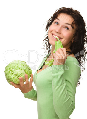 Beautiful young girl with green cabbage