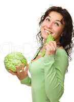 Beautiful young girl with green cabbage