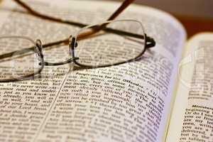 Open Bible with reading glasses
