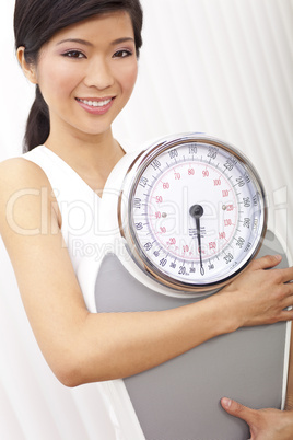 Oriental Asian Chinese Woman Holding Weighing Scales at Gym