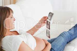Attractive pregnant woman looking at a sonography