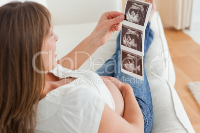 Charming pregnant woman looking at a sonography