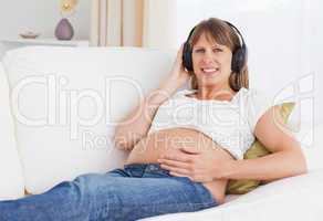 Close up of a pregnant woman listening to music