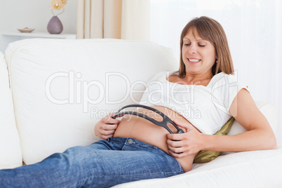 Pregnant woman with headphones on her belly
