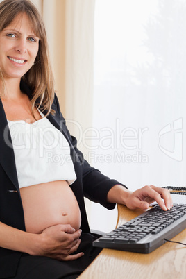 Beautiful pregnant woman working with a computer Beautiful pregnant woman working with a computer