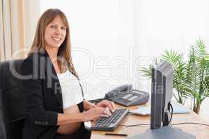 Lovely pregnant woman working with a computer