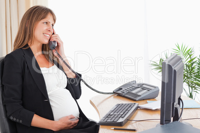 Attractive pregnant woman on the phone
