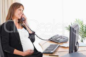 Attractive pregnant woman on the phone