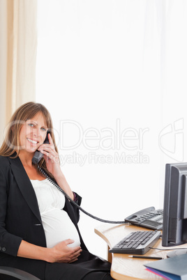 Good looking pregnant woman on the phone